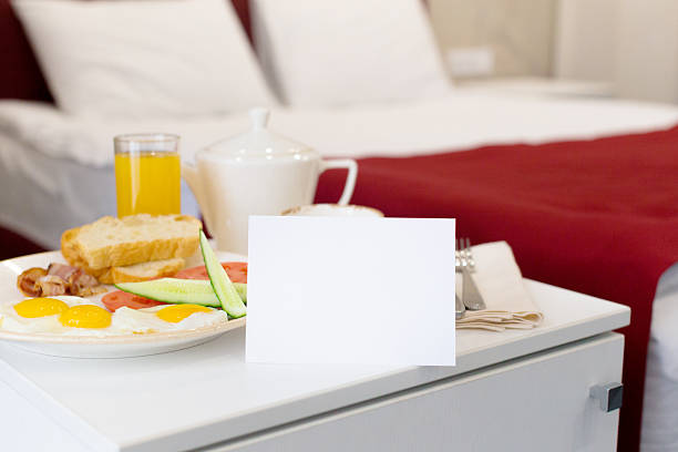 Breakfast served in a hotel room with fresh food and drink on a bedside table
