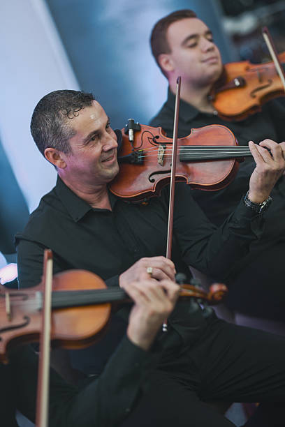 istock Violinist Plays With Focus In A Live Music Session During Ensemble Performance 2245484712