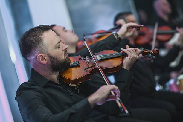 istock Violin Ensemble In Session: Musicians Playing Strings Together In A Live Performance 2245484909