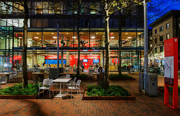 Cambridge, Massachusetts, USA -October 31, 2025: View from the Massachusetts Avenue sidewalk of Harvard University's Smith Campus Center at night. The Smith Campus Center is a Brutalist-style administrative and service building located in Harvard Square in Cambridge, Massachusetts. Originally known as Holyoke Center, in 2013 it was renamed the Richard A. and Susan F. Smith Campus Center. Over the next several years, its underwent extensive renovation to create gathering, lounge, and study spaces, and space for exhibitions, events, and performances, after reopening in 2018.