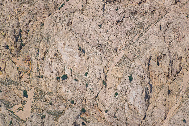 Rocky mountain terrain with sparse vegetation and rugged landscape.