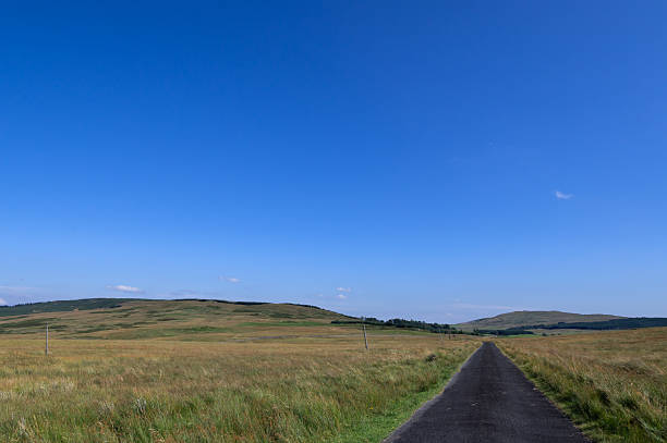 Single lane rural road in a remote location in Scotland on a bright autumn day