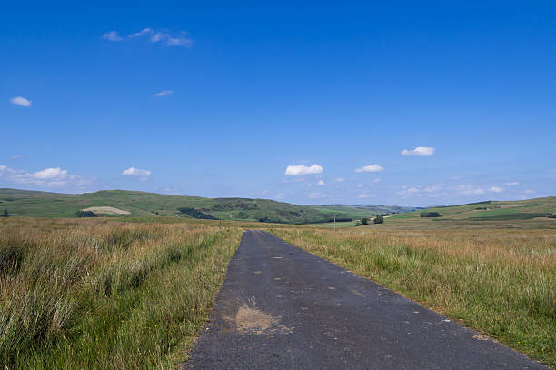Single lane rural road in a remote location in Scotland on a bright autumn day