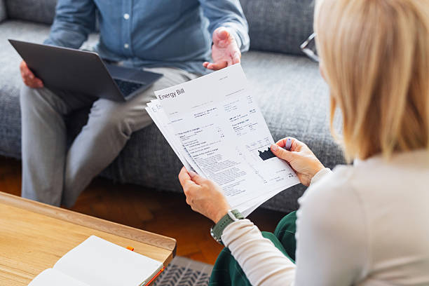 istock Home Meeting Reviewing Energy Bill Documents With Laptop On Couch 2245493634