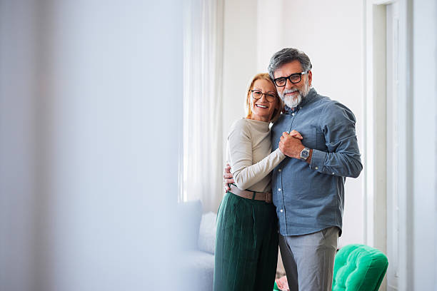 istock Happy Couple Hugging In Bright Hallway, Warm Embrace, Seniors Share Affection 2245493662