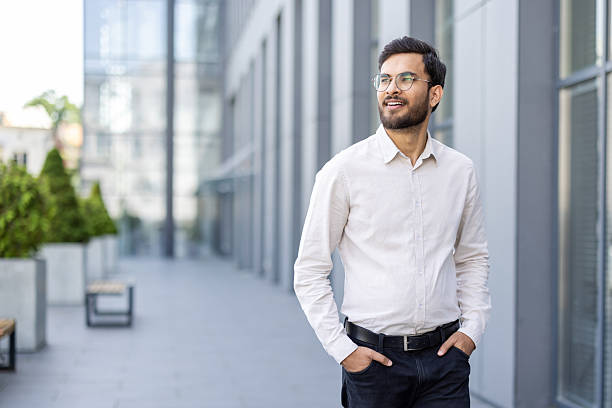 istock Confident professional walking outdoors in an urban office environment 2245494678