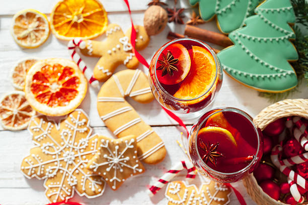 Festive holiday drinks with cookies and decorations on a wooden table