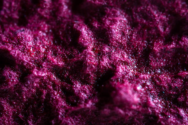 Extreme close up of purple handmade paper clay with a structure and rough texture.