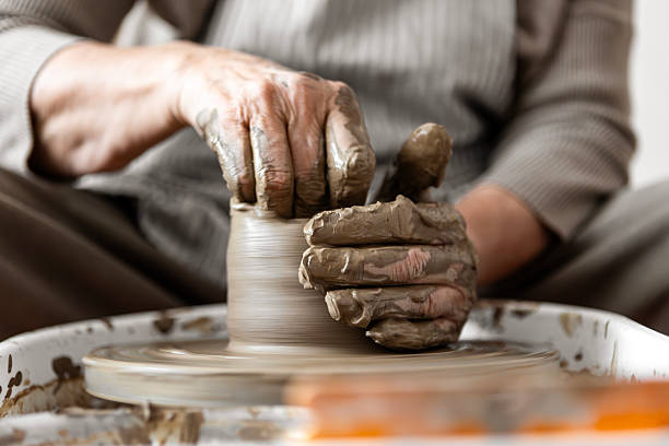 istock Female Potter Working with Clay On Pottery Wheel 2245497871