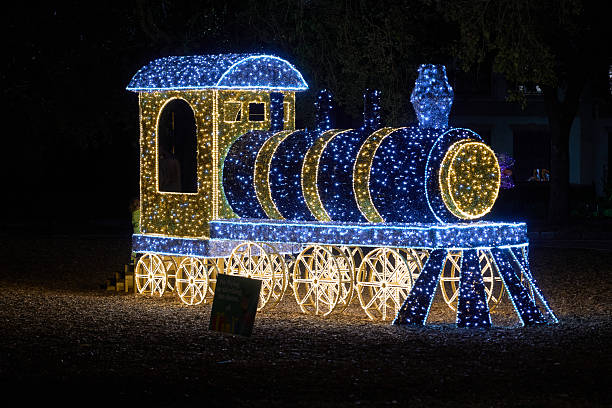 istock Holiday Light Train and Giant Teddy Bear at Night 2245499775