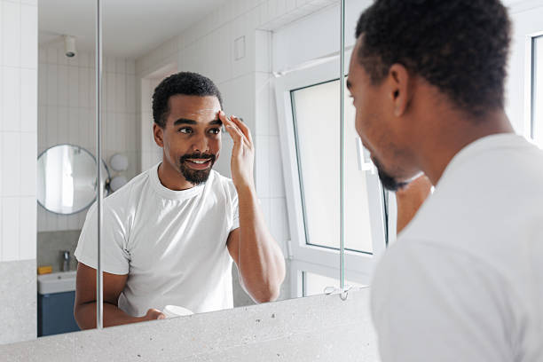 istock African American man grooming in bathroom mirror 2245500025