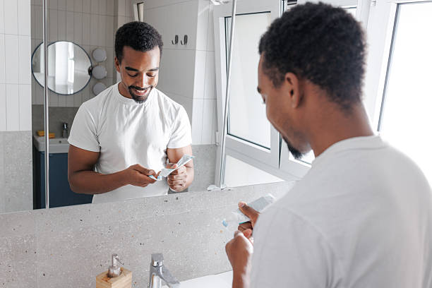 istock Young man is brushing his teeth in the bathroom 2245500069