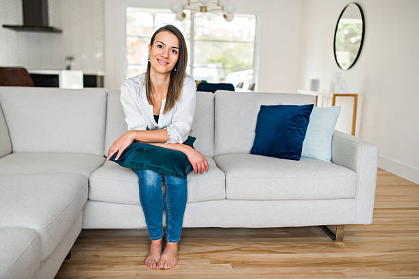 istock Brunette having good time on the living room 2245502273