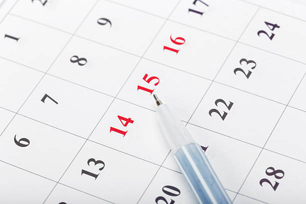 istock Calendar with marked dates and a blue pen on a white background 2245505789