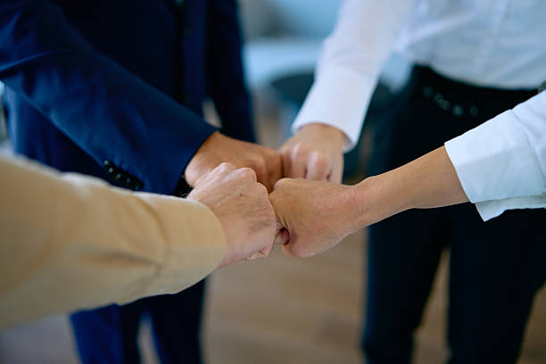 istock Business people fist bumping in office for teamwork 2245507507