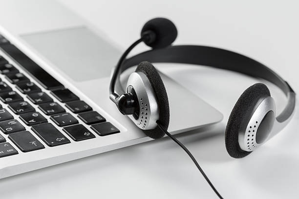 istock Headset placed next to a laptop on a clean workspace 2245507520
