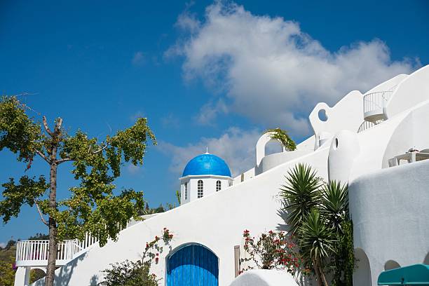 old dovecote at the entrance to the port of Gavrio, small port of Andros, famous Cycladic island, in the heart of the Aegean Sea.