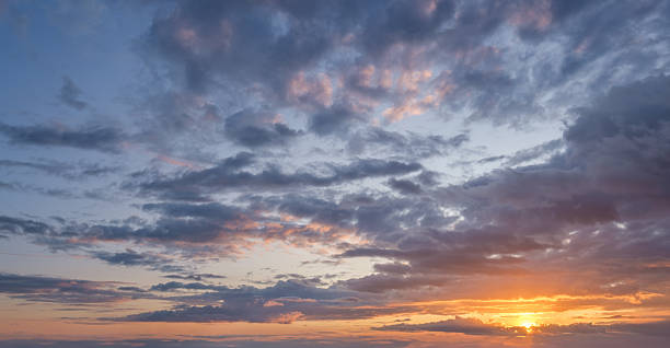 istock Dramatic sunset sky with colorful clouds over scenic horizon at dusk 2245512340