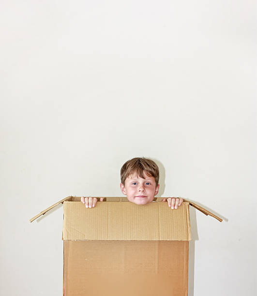 istock Child in cardboard box on white background 2245512414