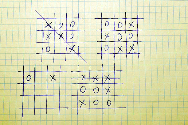 On a notebook sheet with checkered paper, several tic-tac-toe game signs are drawn with a pen.