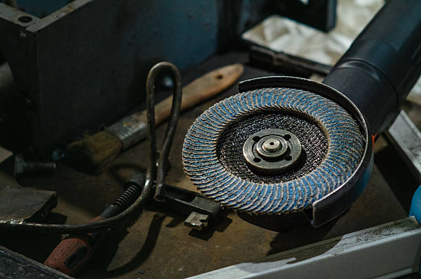 istock Flap sander on table in workshop, with dust, black background. Concept of construction, restoration. 2245515172