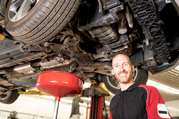 istock handsome mechanic based on car in auto repair shop 2245515876