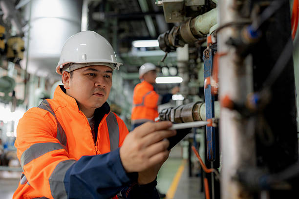 istock Two engineers in safety uniforms check valve and pipeline systems inside an oil refinery. They use a digital tablet to analyze performance, ensuring efficient production, safety, and sustainability in the petrochemical and energy industry. 2245515888