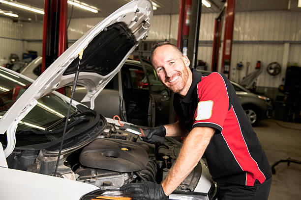 istock handsome mechanic based on car in auto repair shop 2245515957