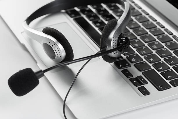 istock Headset resting on laptop keyboard during call setup in a home office 2245519156