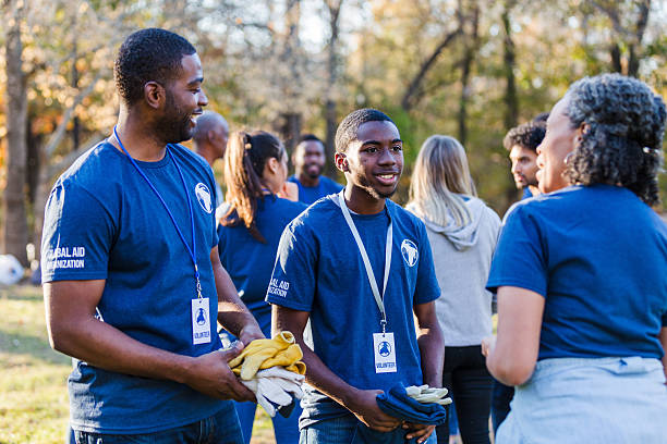 istock Diverse group of volunteers gathered outdoors, smiling and interacting. 2245519844