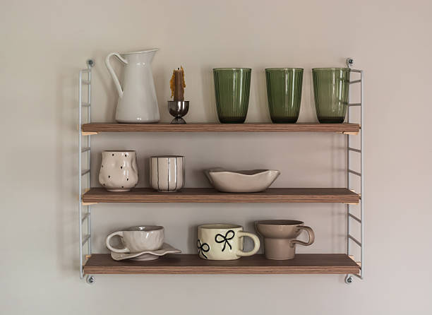 istock Wooden shelf with ceramic dishes on the wall in the kitchen interior 2245522437