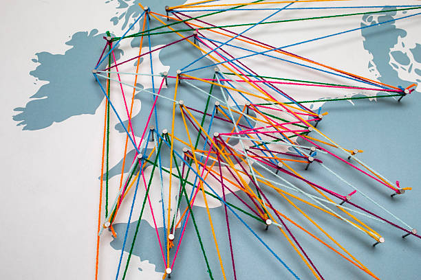 Connection concept: Major UK towns and cities connected to European cities, randomly linked by wool of differing colours tied to nails.