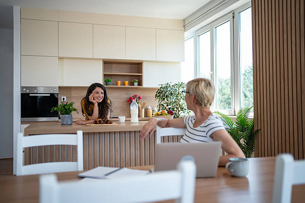 istock Mother and daughter talking enjoying morning breakfast together 2245523521