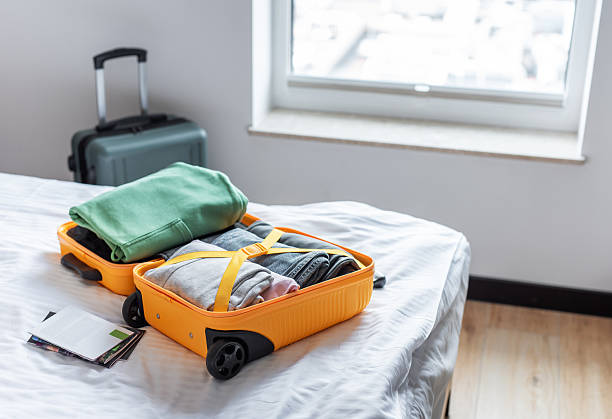 istock Open suitcase filled with clothes packing for travel 2245527625
