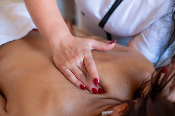 istock Professional massage therapist giving relaxing back treatment at spa 2245527765