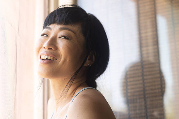 istock Happy asian woman smiling enjoying natural light 2245530170
