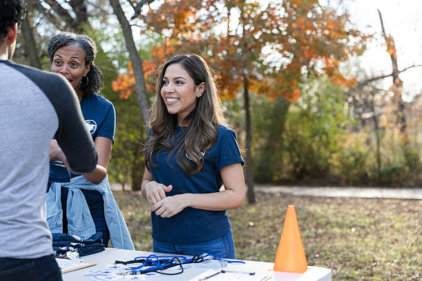 istock Smiling volunteers interacting outdoors, engaged in community service during autumn. 2245532172
