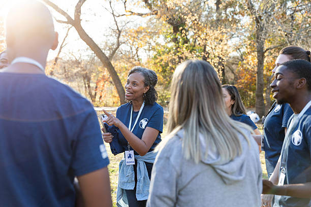 istock Diverse group of volunteers receiving instructions outdoors on a sunny day. 2245532184