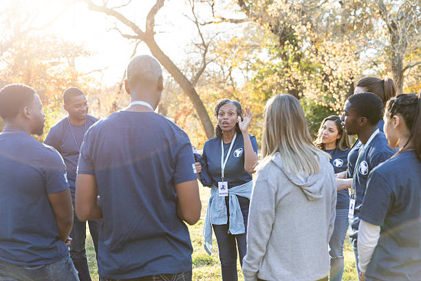 istock Diverse group of volunteers collaborating outdoors during daylight hours. 2245532213