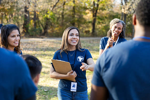 istock Volunteers gather outdoors for a community event, engaging in a discussion. 2245532670