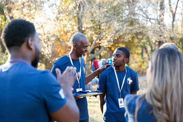 istock Diverse group of volunteers collaborating outdoors for a community project. 2245532727