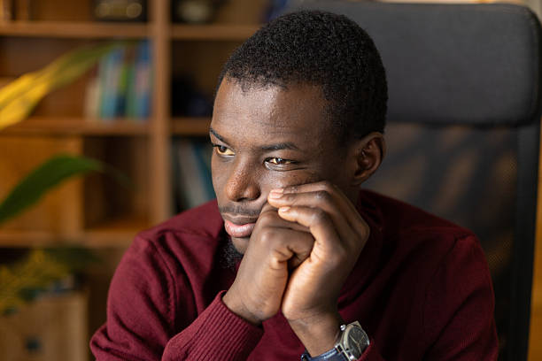 istock Young adult african man looking away thinking about problems and solutions 2245533461