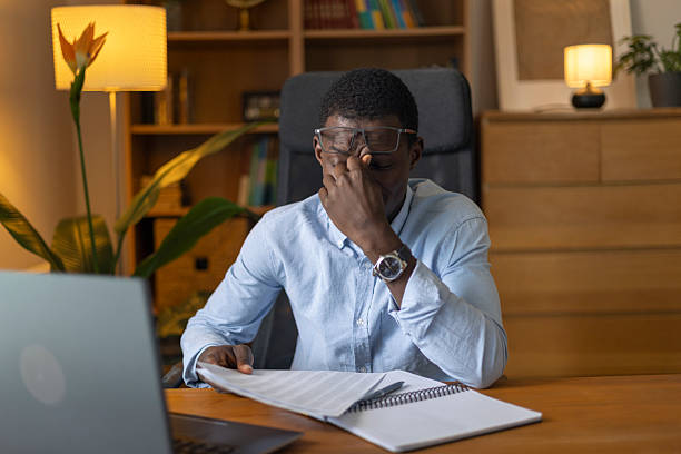 istock Stressed young adult man experiencing burnout and headache while working at home 2245534445
