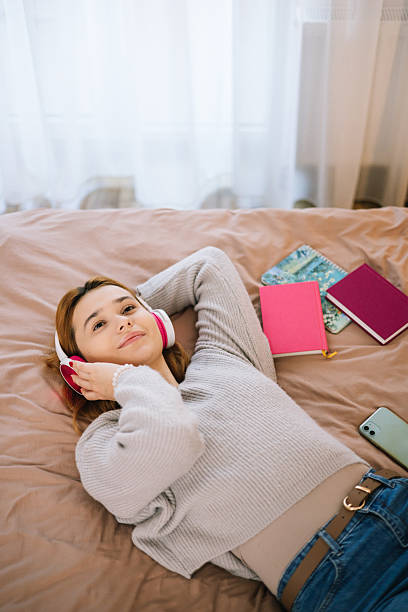 istock Young woman relaxing on the bed after studying 2245543229