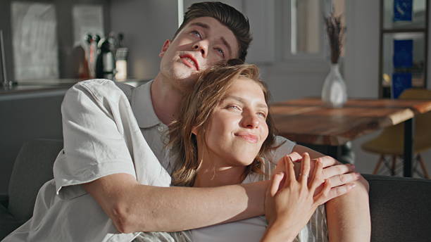 istock Married couple embracing home in sunlight. Closeup loving partners communicating 2245546317