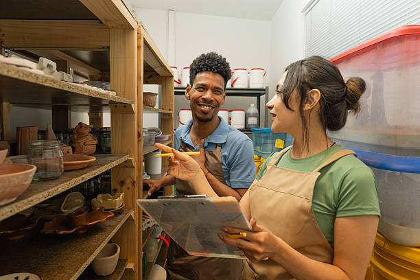istock Female and male craftspeople performing inventory in pottery workshop 2245549064