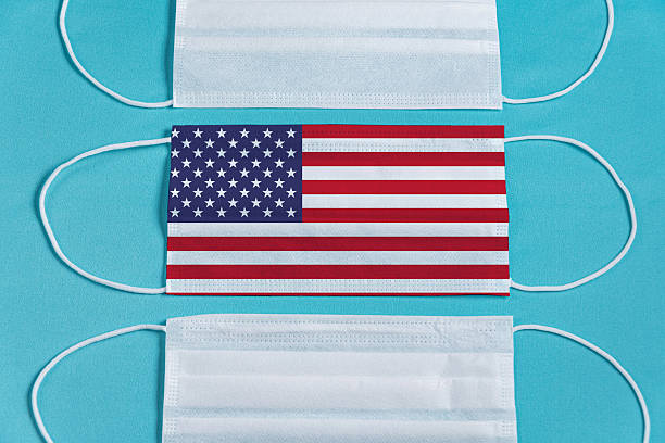 istock Surgical mask over minimalist blue background 2245549719