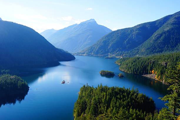 istock Blue Alpine Lake with Forested Mountains 2245550393
