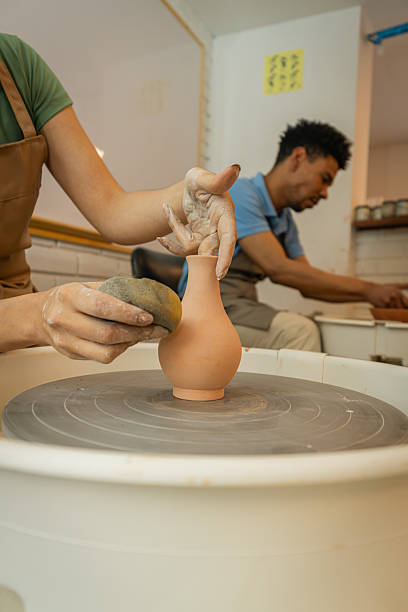 istock Creating pottery: woman and man making ceramic products 2245550696
