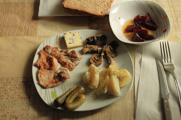 Classic, healthy lunch: steak, boiled potatoes, beetroot in olive oil, blue cheese, pickles, wholegrain bread